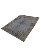 Alfombra vintage persa rectangular gris-azulada con diseño envejecido y textura marcada.
