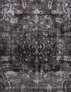 Alfombra vintage persa: detalle del patrón gris y negro con textura envejecida