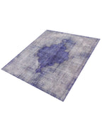 Alfombra vintage persa rectangular con patrón desgastado y medallón morado/azul.