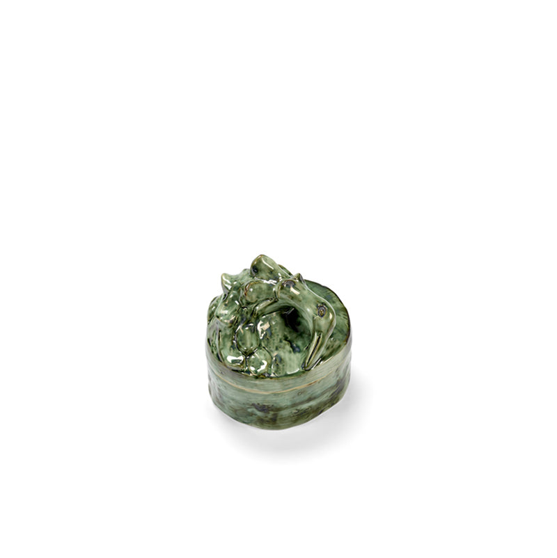 Vela perfumada en recipiente cerámico verde con tapa esculpida y acabado texturizado