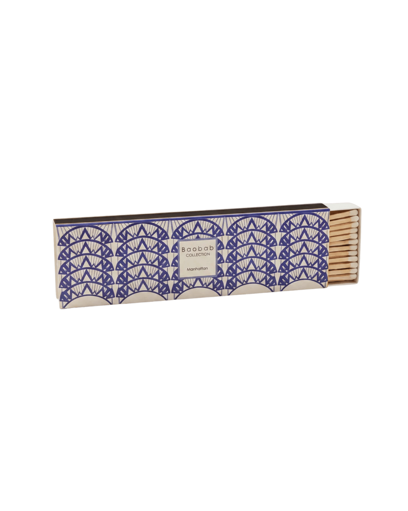 Caja de cerillas Baobab Manhattan azul marino y platino, con cajón parcialmente abierto.