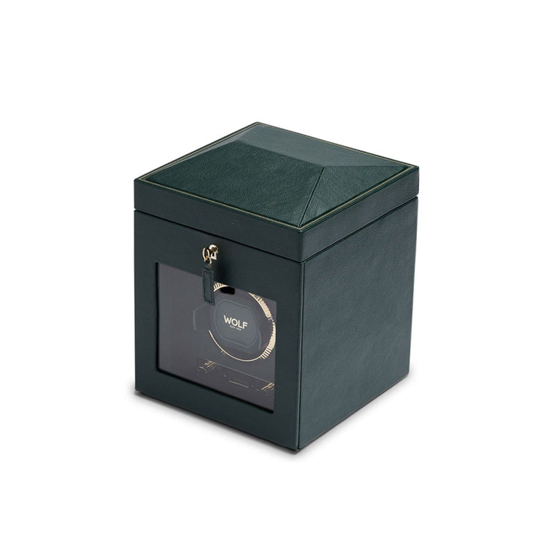 Caja de relojes verde oscuro abierta mostrando compartimentos acolchados y soporte