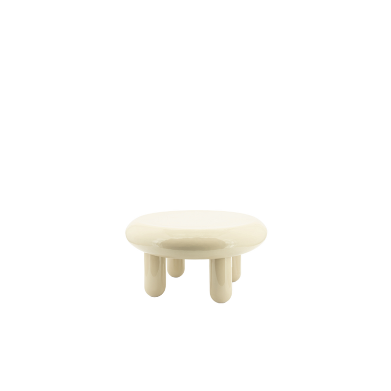 Mesa de centro redonda beige, vista frontal, con sobre redondeado y patas cilíndricas.
