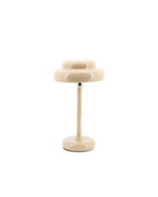 Lámpara de sobremesa Pomm beige con pantalla ovalada doble y pie cilíndrico plateado.