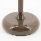 Lámpara de sobremesa Pomm marrón oscuro: base circular y columna central brillante.