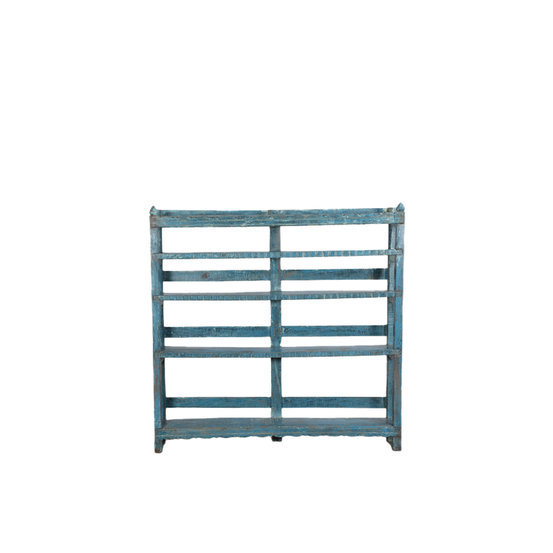 Librería de madera con pátina azul, frentes ranurados y estantes abiertos