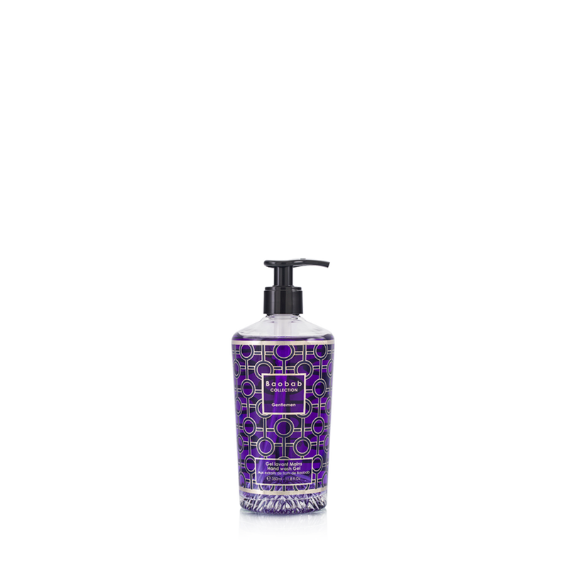 Gel de manos en botella morada con dosificador negro y etiqueta geométrica.