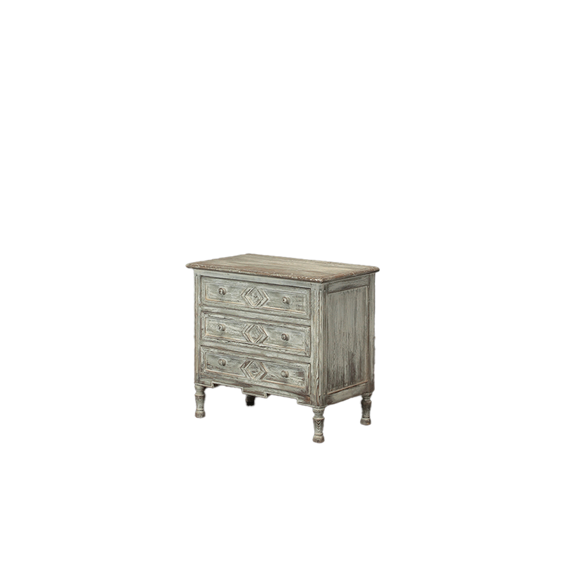 Cajonera de madera con 3 cajones, vista lateral, patas torneadas y acabado gris.