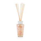 Difusor de aroma con varillas beige y frasco cilíndrico de vidrio con patrón naranja