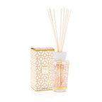 Difusor de aroma con varillas beige, frasco de vidrio con patrón naranja y caja a juego