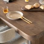 Mesa de comedor de madera natural con plato y cubiertos sobre el tablero