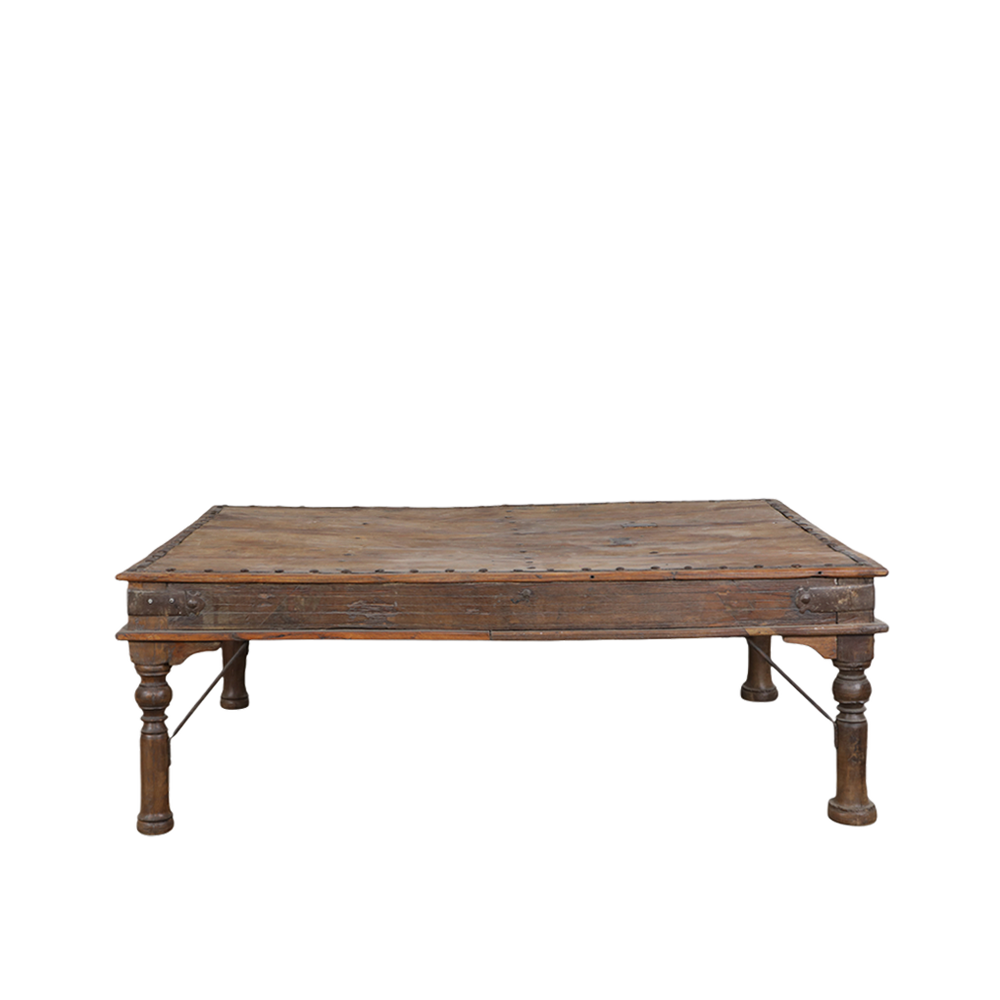 Mesa de comedor artesanal de madera oscura con patas torneadas y bordes marcados