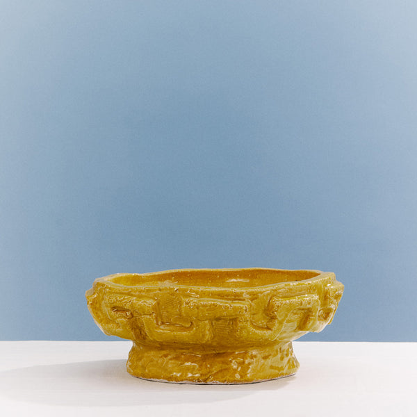 Cuenco de cerámica amarillo con textura en relieve y borde irregular