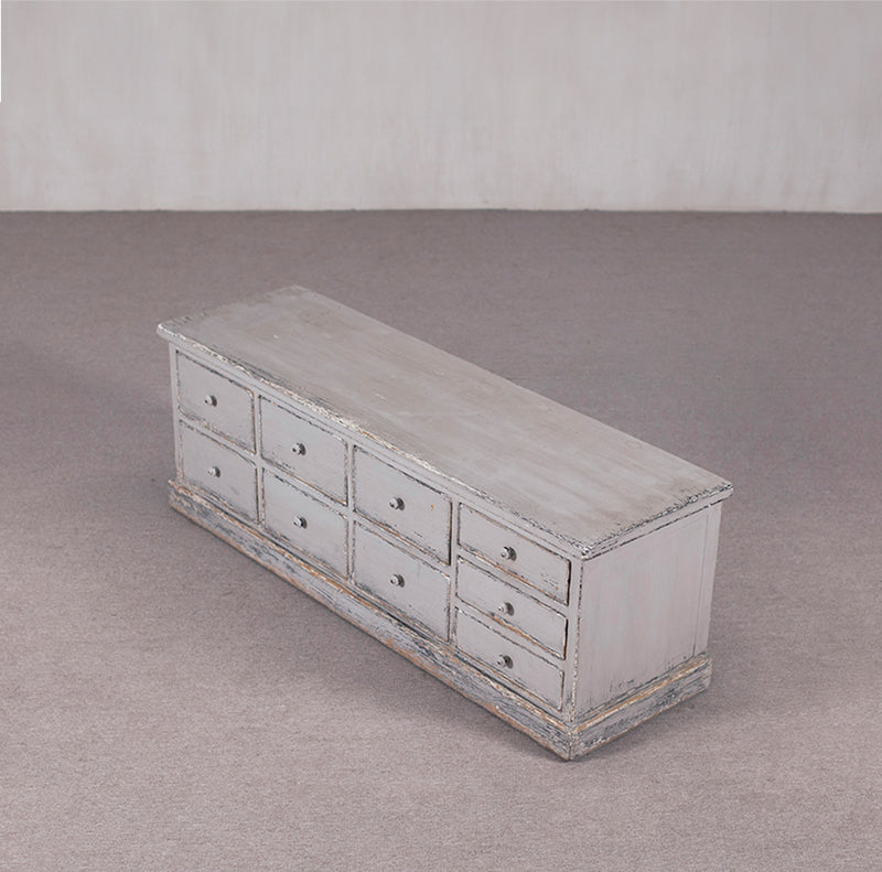 Aparador gris Heritage con 9 cajones, tapa superior clara y base de madera envejecida