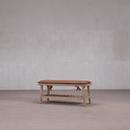 Banco de madera con zapatero, tablero superior marrón y repisa de listones visible.
