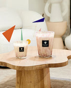 Par de velas en vasos de vidrio con cera blanca y etiqueta Baobab Collection