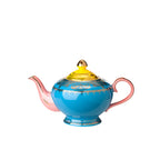 Tetera de porcelana azul con asa y vertedor rosados, tapa dorada decorada