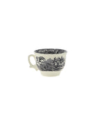 Taza de cerámica negra con asa y decoración de paisaje