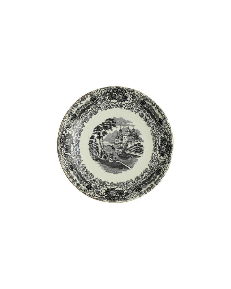Plato de cerámica negro con decoración paisajística y borde ornamentado