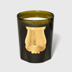 Vela Trudon Cyrnos: frasco negro y cera blanca con emblema dorado en relieve
