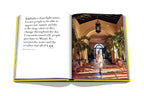 Libro de fotografía abierto con pasillo tropical y persona de ropa blanca