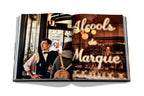 Libro Paris Chic abierto: escena de café con hombre y rótulo decorativo