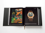 Libro de colección Patek Philippe abierto con reloj con esfera multicolor