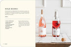 Libro Bubbly abierto: páginas de recetas con bebidas y botellas rojizas a la derecha