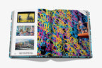 Libro abierto con fotos de murales y persona frente a pared de grafiti multicolor.
