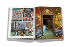 Libro abierto con fotos de decoración y, a la derecha, interior de tienda con arcos.