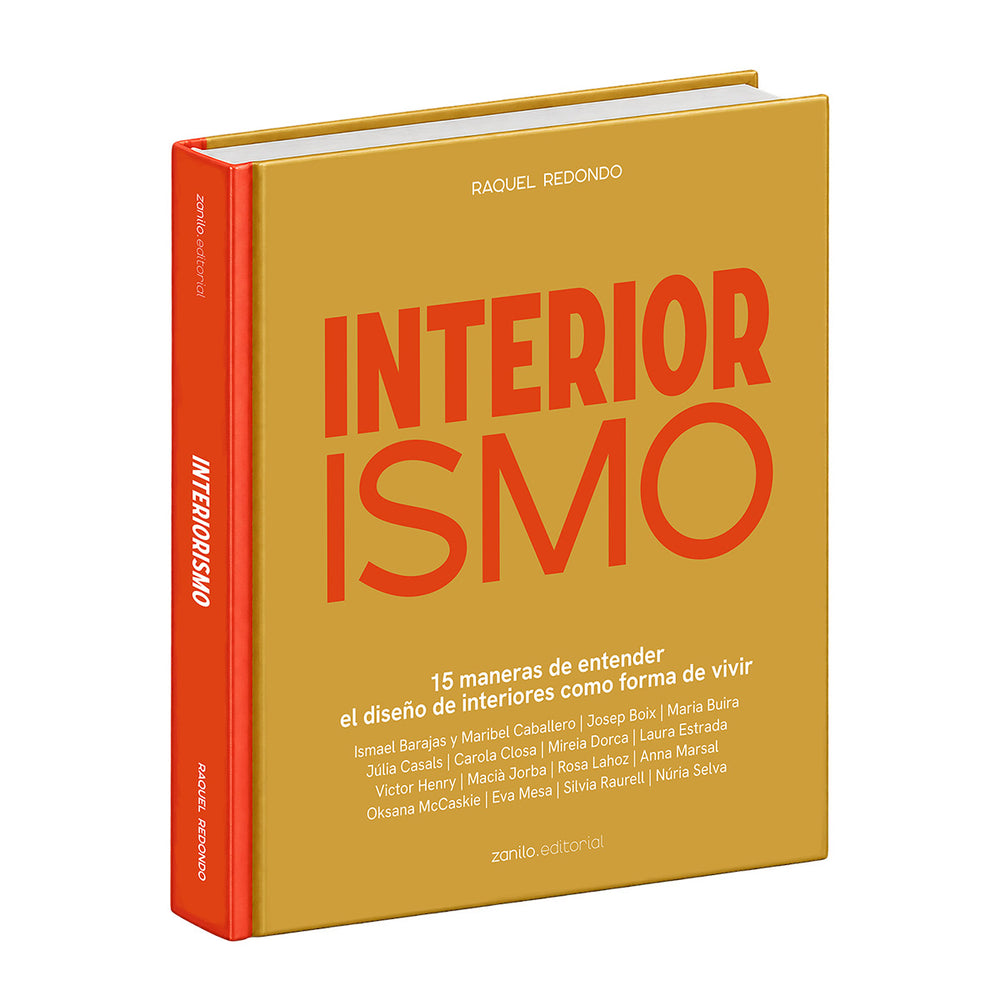 Libro de interiorismo con tapa dorada y letras rojas INTERIOR ISMO