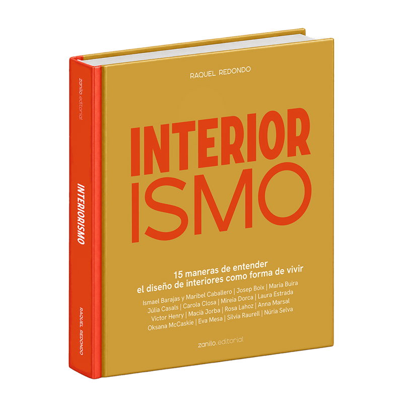 Libro de interiorismo con tapa amarilla y texto “INTERIORISMO” en rojo