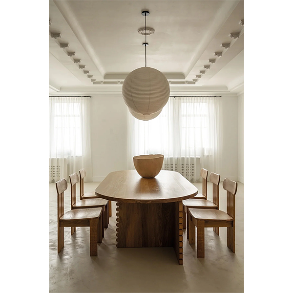 Página del libro con comedor minimalista: mesa redonda y lámpara colgante.