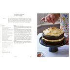 Libro de cocina japonesa abierto con receta y persona sosteniendo un pastel de crema
