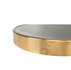 Espejo circular dorado: marco metálico con etiqueta rectangular en el borde