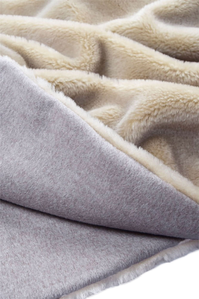 Beige plush throw blanket with sherpa trim and layered folded edge